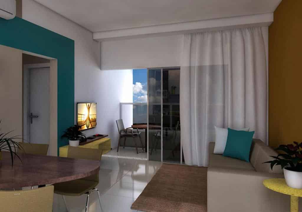 flat do Enjoy Solar das Águas Park Resort mostrando uma moderna sala de estar com sofá, TV, mesa de jantar e portas de vidro deslizantes que levam a uma varanda com assentos ao ar livre.