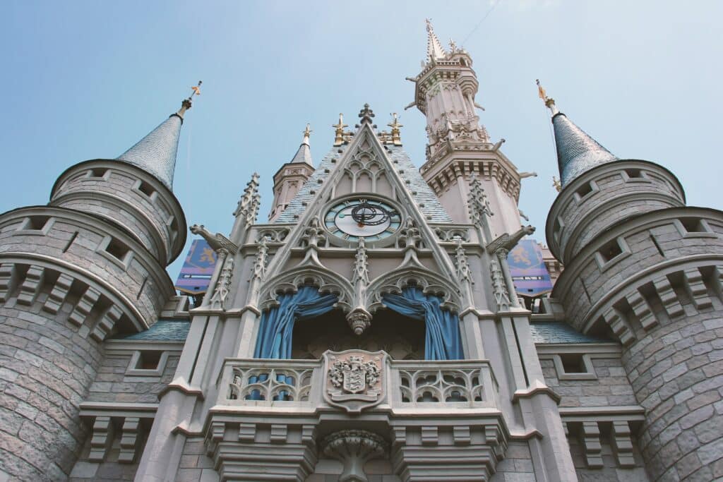 vista de perto e de baixo do castelo com inspiração gótica e barroca, bem detalhado em branco com detalhes em azul no The Magic Kingdom, na Disney, uma das opções de onde ficar em Orlando